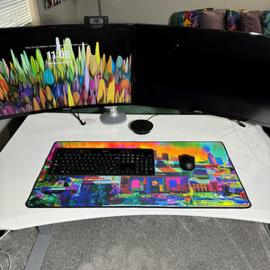 colorful neoprene desk mat on a white desk with a keyboard and mouse