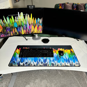 colorful neoprene desk mat on a white desk with a keyboard and mouse