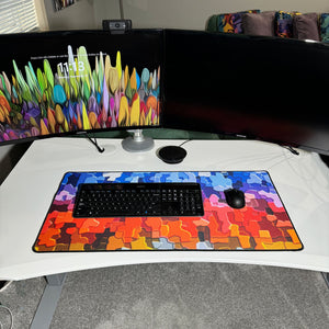 colorful neoprene desk mat on a white desk with a keyboard and mouse