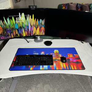 colorful neoprene desk mat on a white desk with a keyboard and mouse